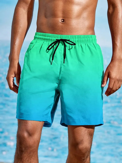 Men's grey gradient print sports shorts made from breathable mesh fabric, shown on a model.