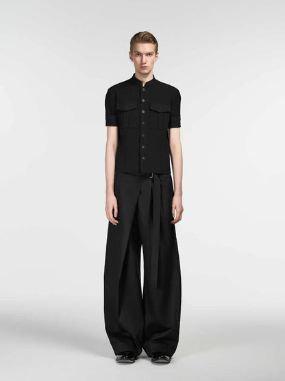 Black straight-leg trousers with single front pleat and adjustable waistband on a hanger