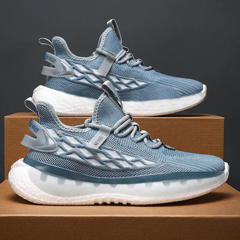 Men's white low-top sneakers with mesh upper and flat rubber sole on a grey background.