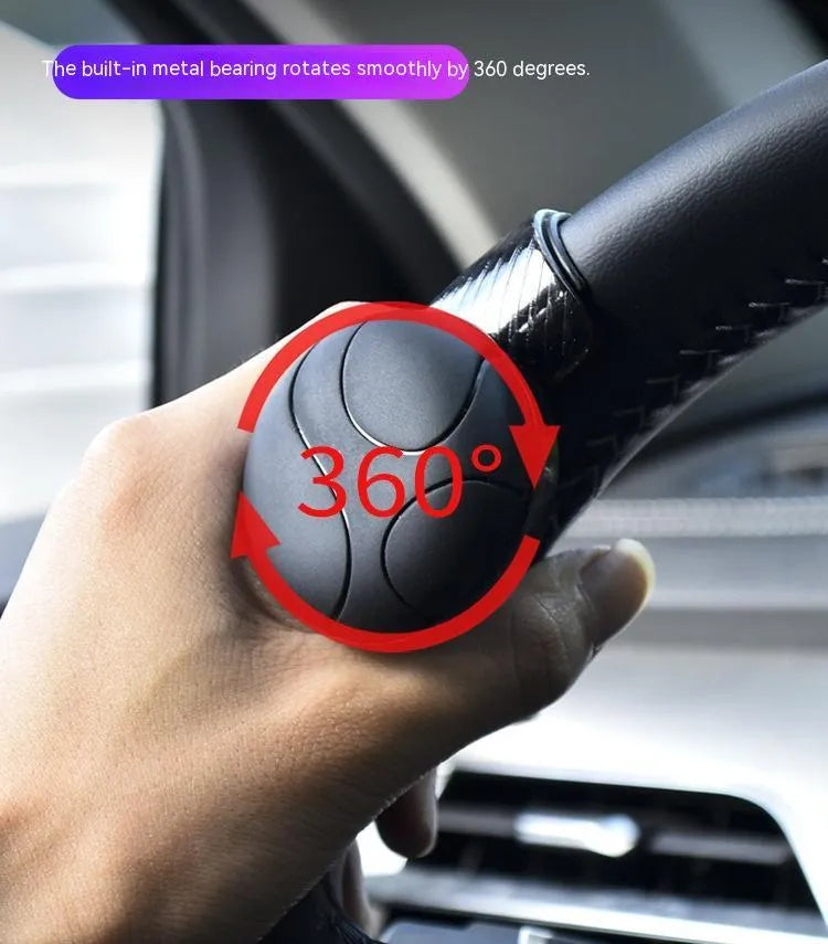Black steering wheel assist ball with silicone grip mounted on car steering wheel