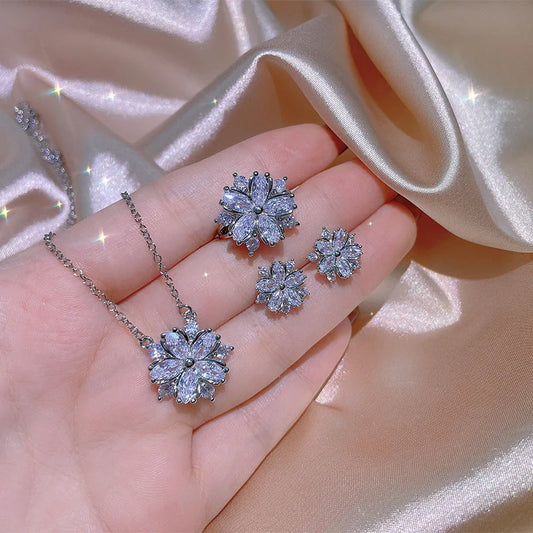 Dazzling cubic zirconia jewellery set with double-layered flower design, including ring, necklace, and earrings in pink and white diamond colours