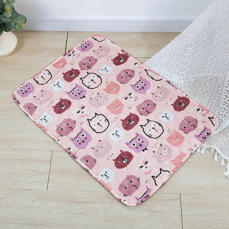 Reusable washable pet urine pad showing colourful animal pattern and waterproof backing.