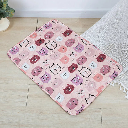 Reusable washable pet urine pad showing colourful animal pattern and waterproof backing.