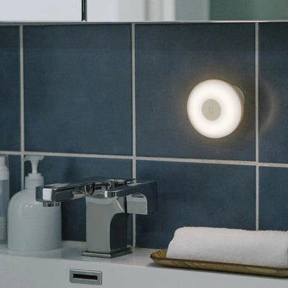 White Mijia Bluetooth bedside lamp with human body sensor on a wooden table.