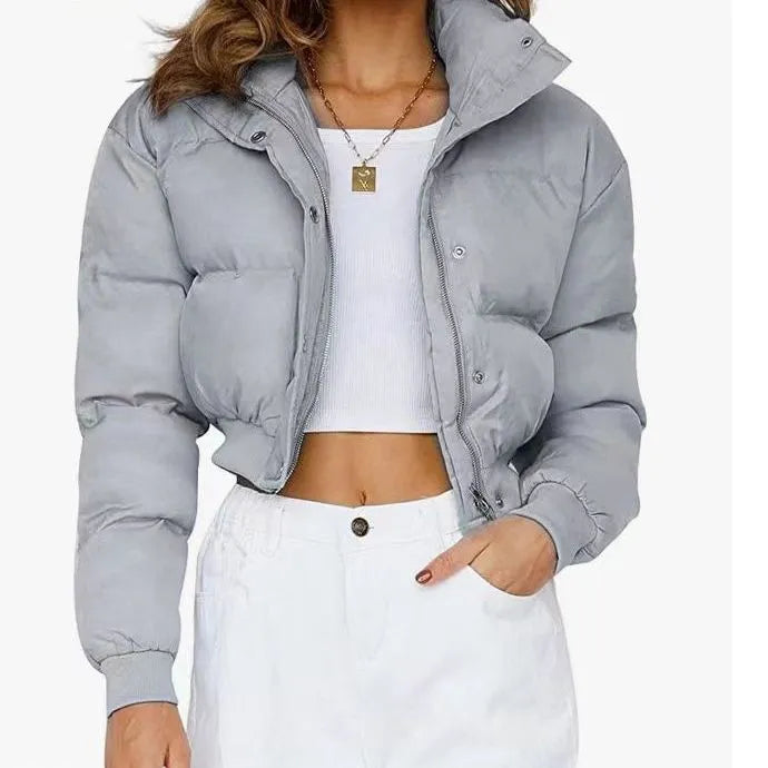 Loose blue polyester jacket for women on a hanger, showing long sleeves and front zip.
