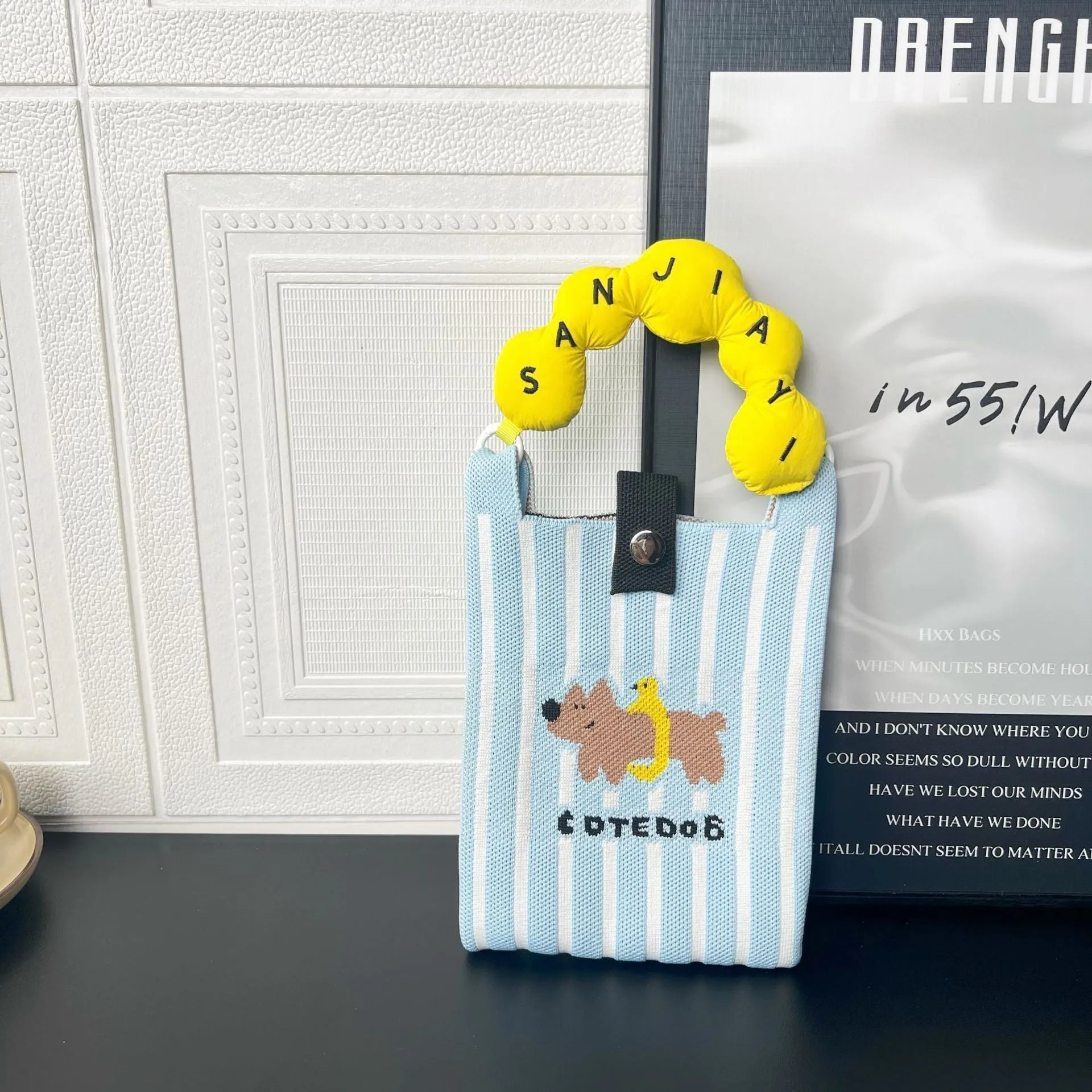 Cartoon knitted messenger bag with polyester construction and internal mobile phone storage