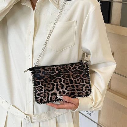 Western style women's brown crossbody bag with chain strap and horizontal square silhouette