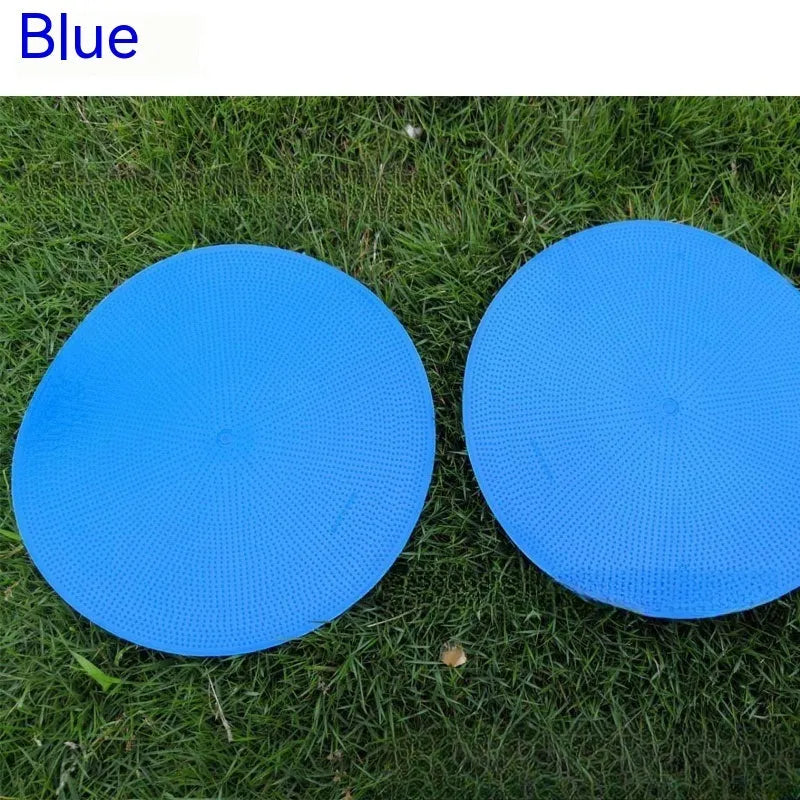 Soft yellow TPE football training landmark pad disc on grass, 23cm diameter.