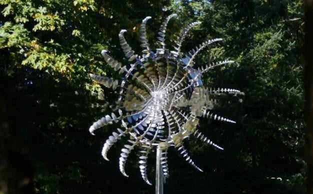 Elegant stainless steel outdoor windmill spinner with dual-layered blades rotating in opposite directions, creating a mesmerising display in the garden