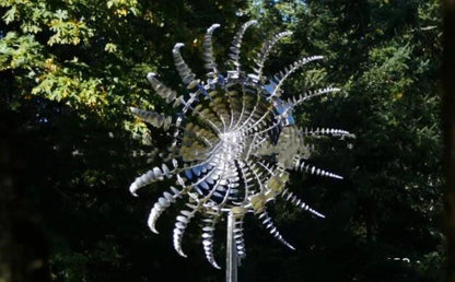 Elegant stainless steel outdoor windmill spinner with dual-layered blades rotating in opposite directions, creating a mesmerising display in the garden