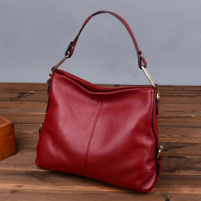 Black genuine leather vertical crossbody bag with multiple internal compartments and a sandwich pocket.