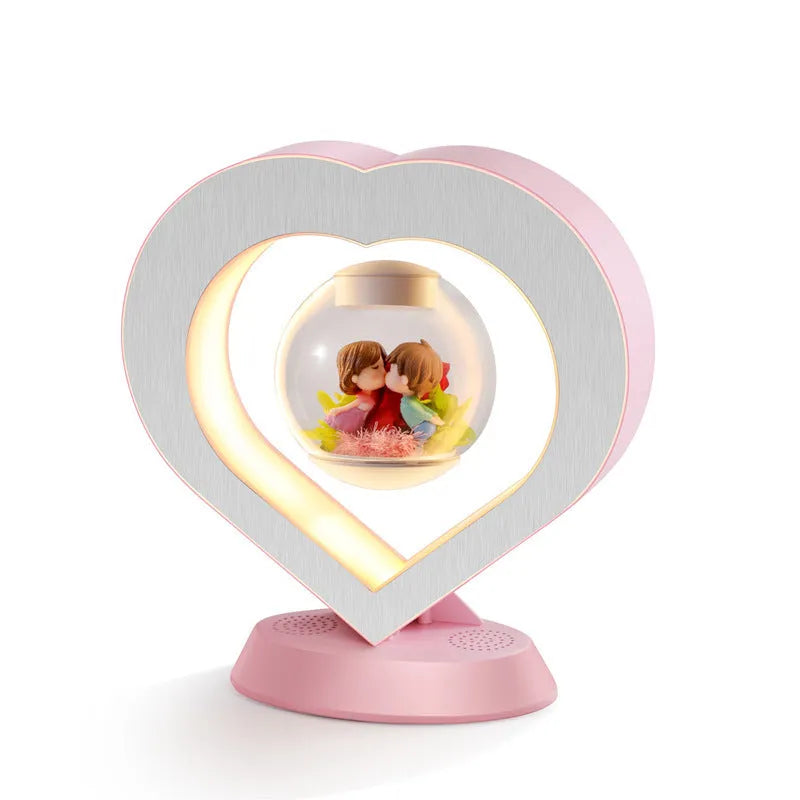 Pink rose eternal flower floating in magnetic levitation LED night light with triangular base and touch control