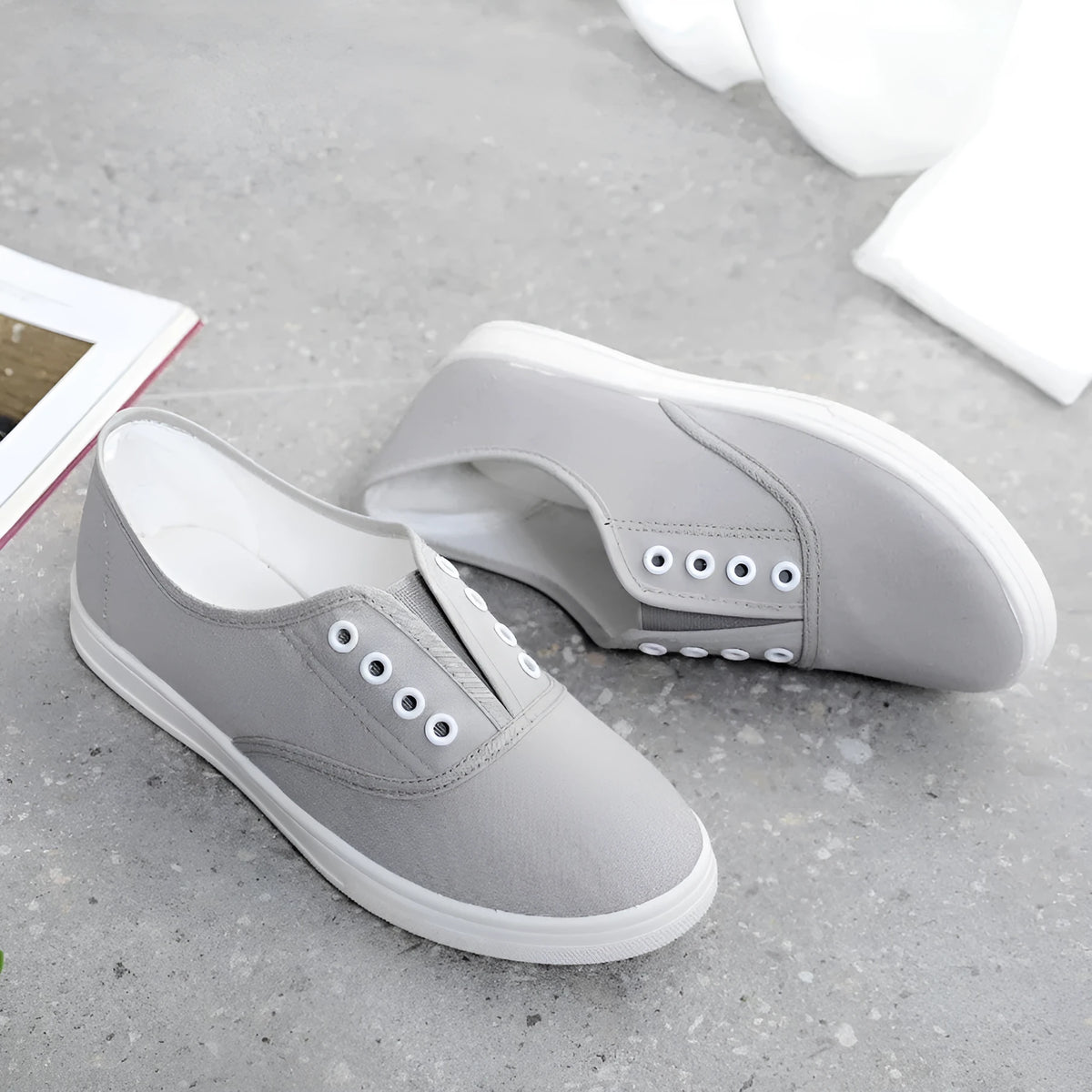 A pair of low-top canvas casual trainers in a choice of colours, shown on a flat surface.