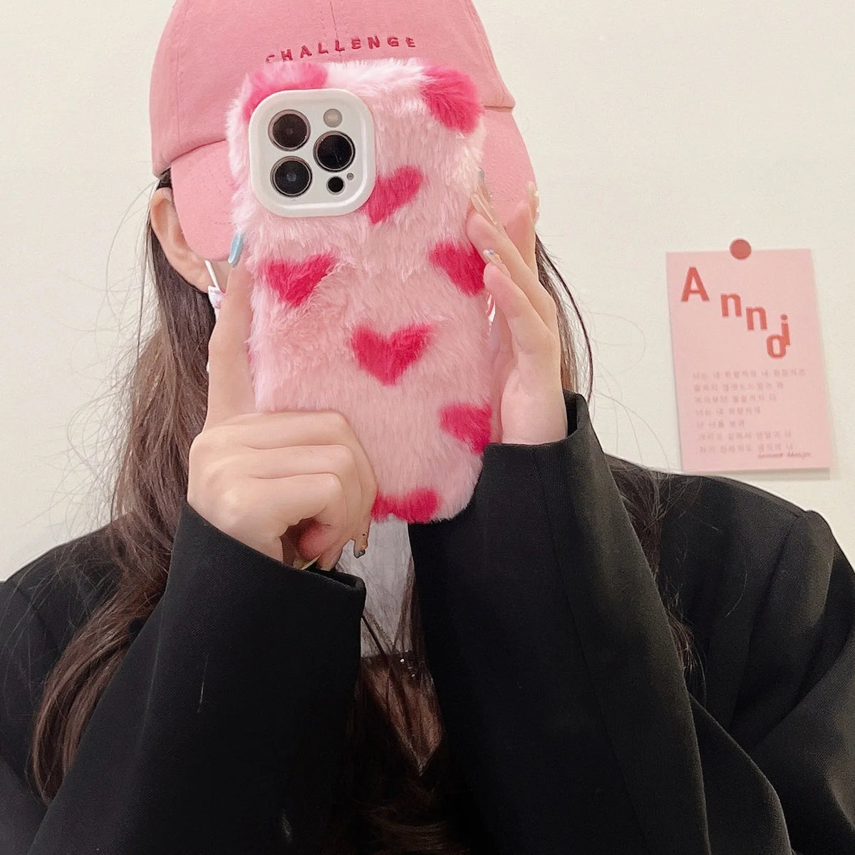 Pink silicone iPhone case with a cartoon design on the back