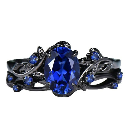 Geometric black women's couple ring with navy blue rhinestone inlay showing side profile