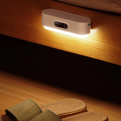 White magnetic USB rechargeable LED night light with touch controls, shown attached to a metal surface.