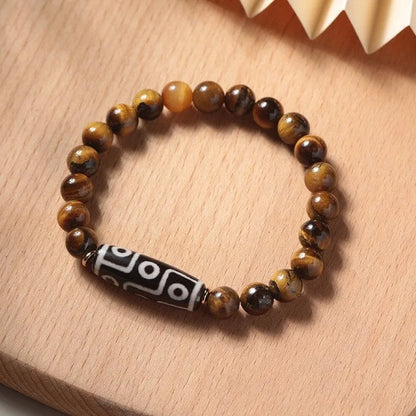 Tigereye dzi bead buddha bracelet with adjustable closure, shown in simple bracelet style.
