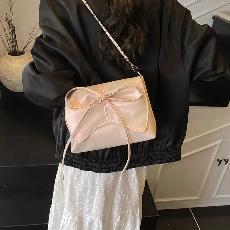 Black horizontal square PU crossbody bag showing internal mobile phone pocket and crossbody strap