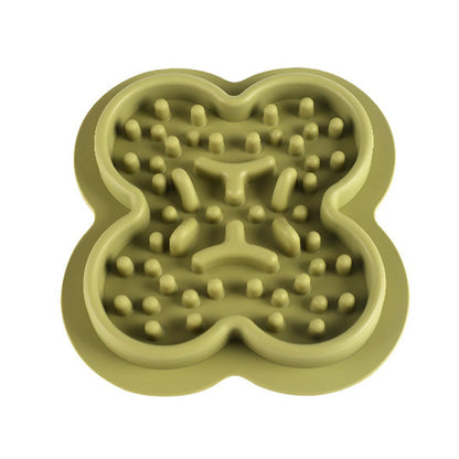 A raised silicone pet licking pad placed on a floor, showing its textured surface and non-slip base.