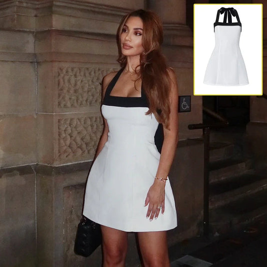 Elegant black and white mini dress with halter neckline, sleeveless design, and short skirt length