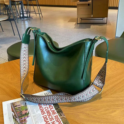 Women's black genuine leather shoulder messenger bag showing structured square shape and single strap.