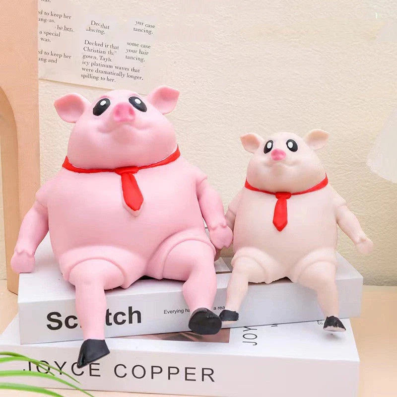 Adorable piggy-shaped stress relief toy made of eco-friendly rubber with a charming red scarf design