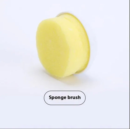 White cordless electric spin scrubber with multiple brush heads on a bathroom tile.