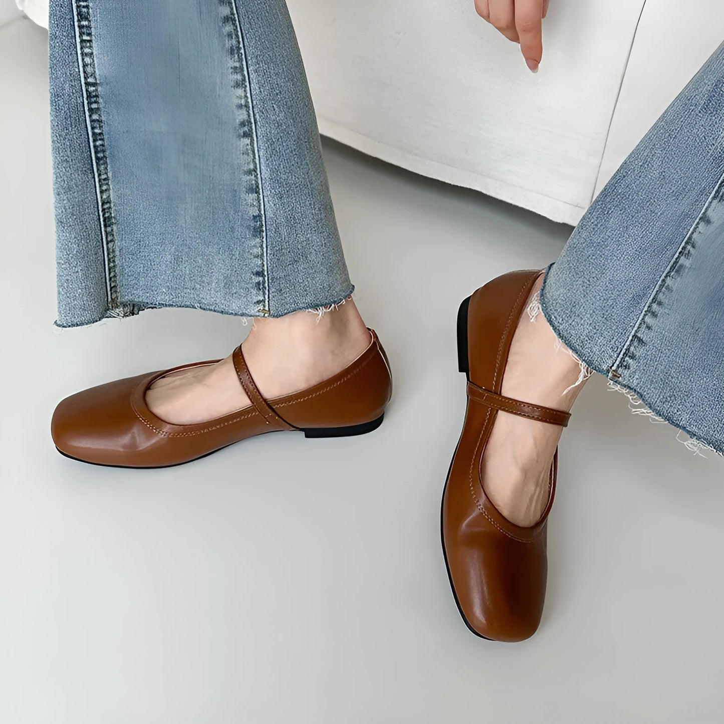 Women's sheepskin Mary Jane flat shoes in brown, showing round toe and low heel.