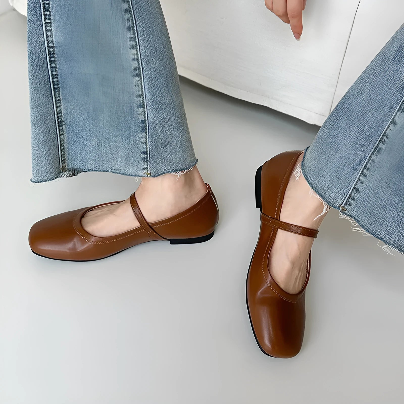 Women's sheepskin Mary Jane flat shoes in brown, showing round toe and low heel.