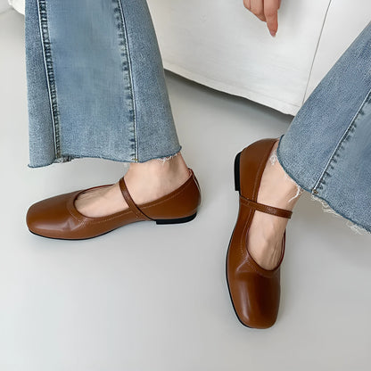 Women's sheepskin Mary Jane flat shoes in brown, showing round toe and low heel.