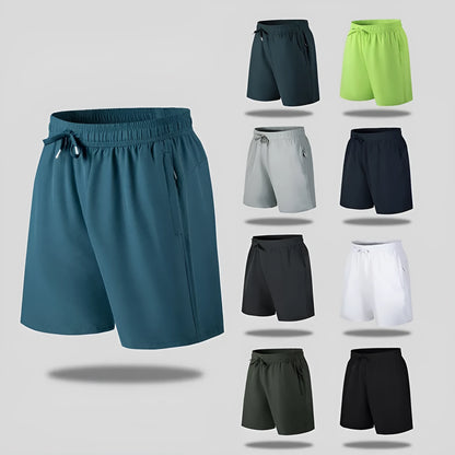 Man wearing black loose-fit quick-dry polyester sports shorts on a summer day.