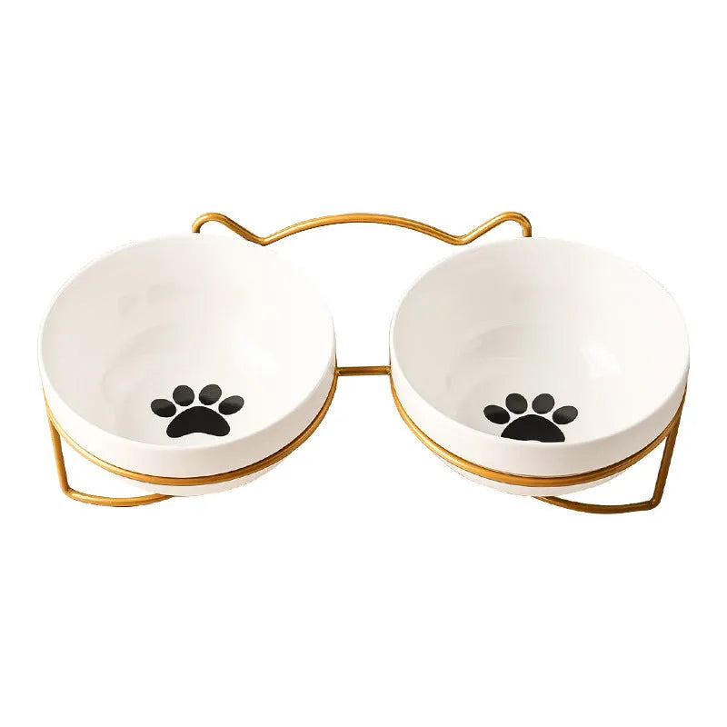 White ceramic pet bowl with cat paw print in a black iron stand with cat ear details