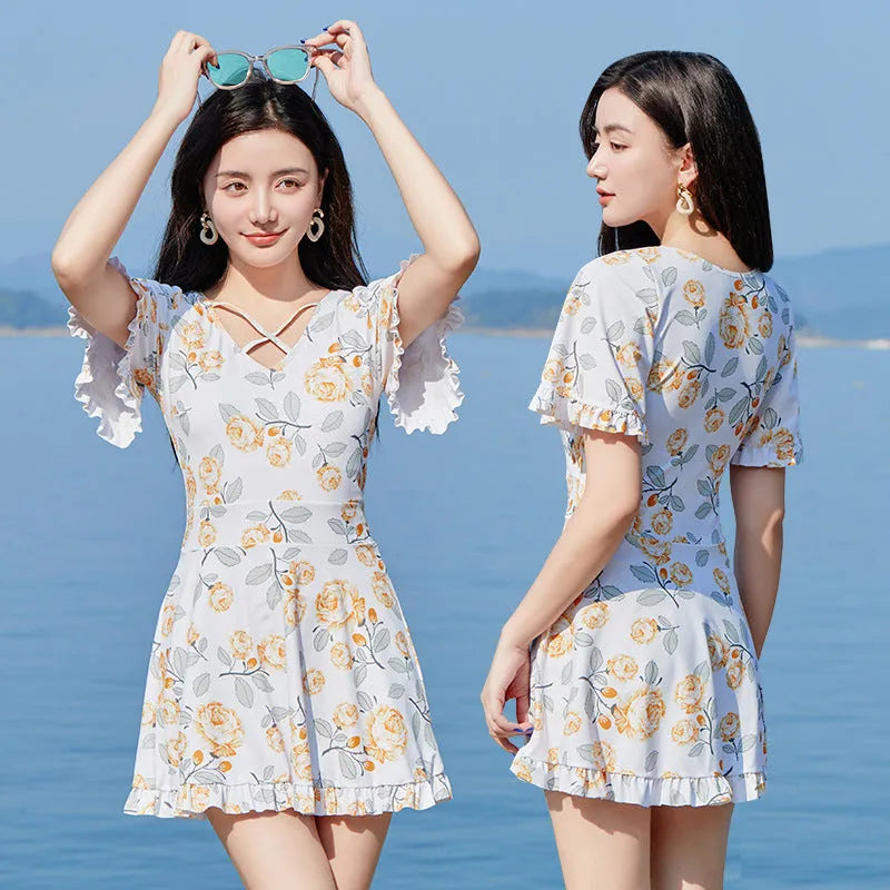 Women's one-piece swimsuit in high waist slimming style with blue floral print, made from polyester fabric for swimming and wading, available in UK sizes M, L, XL, XXL in white and blue colourway.