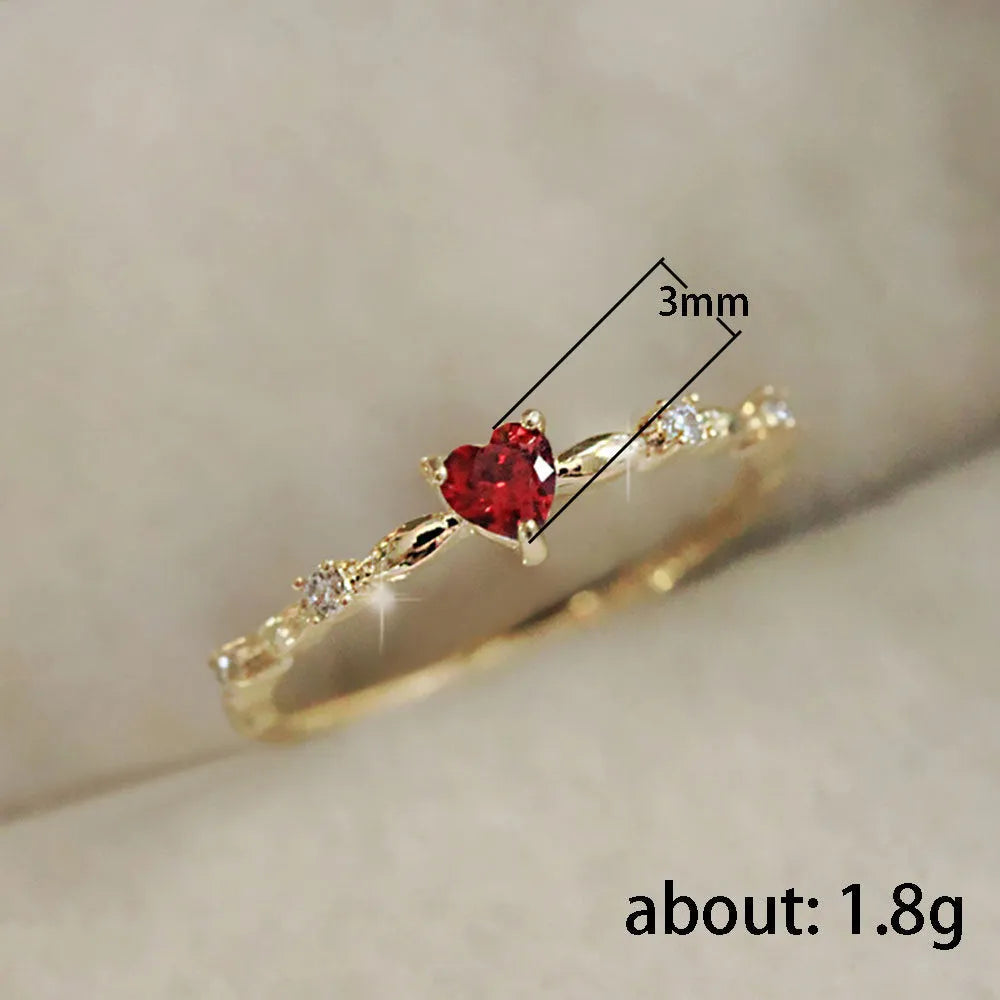 Gold and silver tone peach heart ring with zircon decoration, shown in sizes 6-10
