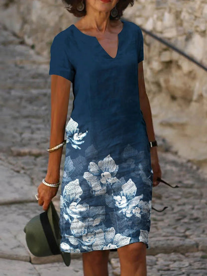 Elegant floral-printed cotton and linen midi dress in various colours with short sleeves and v-neck