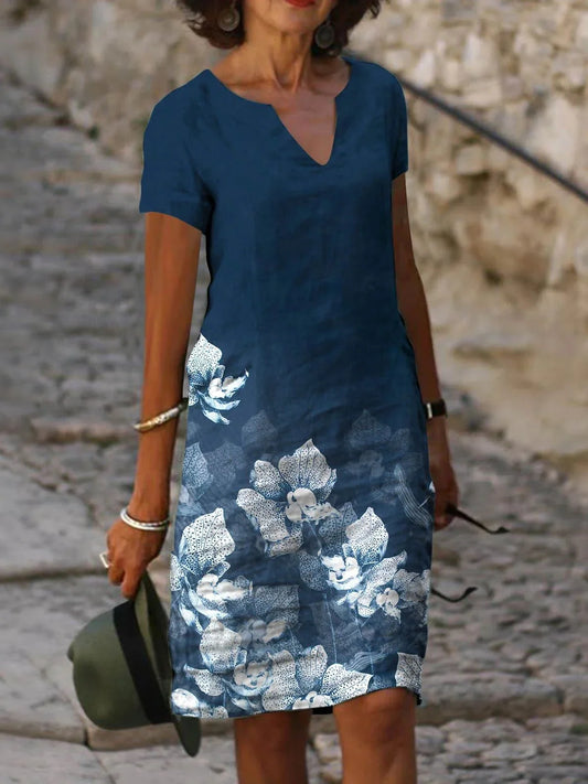 Elegant floral-printed cotton and linen midi dress in various colours with short sleeves and v-neck