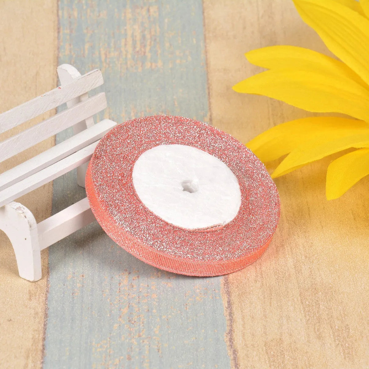 Close-up of green onion patterned ribbon with gold wire on a 25-yard roll, showing 3-points width.