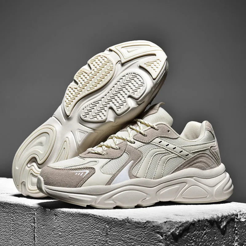 Men's beige and black collapse flat casual sneakers with low heel on a plain background