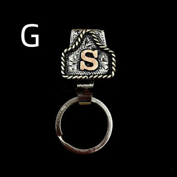 Handmade cow tag design metal keychain on a keyring, shown in one of many available colours.