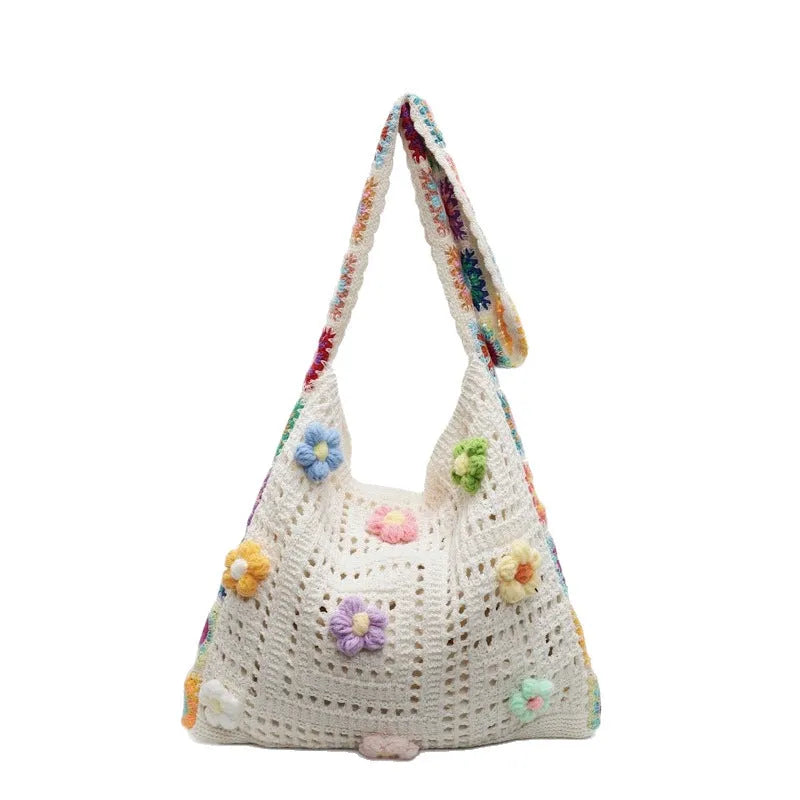 Women's large white knitted shoulder bag with hollow weave pattern and single strap.