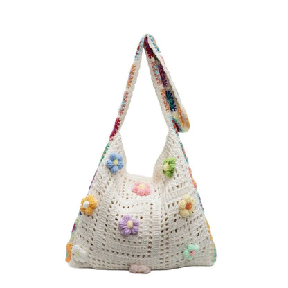Women's large white knitted shoulder bag with hollow weave pattern and single strap.