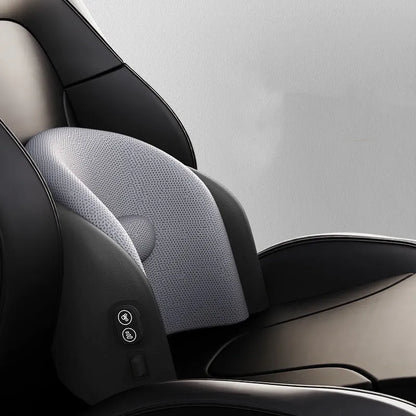 Black car massage cushion with headrest and lumbar support on a car seat, showing wired controller.