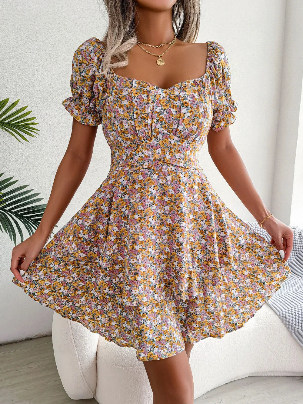 Stylish floral mini dress with ruffled skirt, high-waist design, and short sleeves for a flattering and comfortable summer look