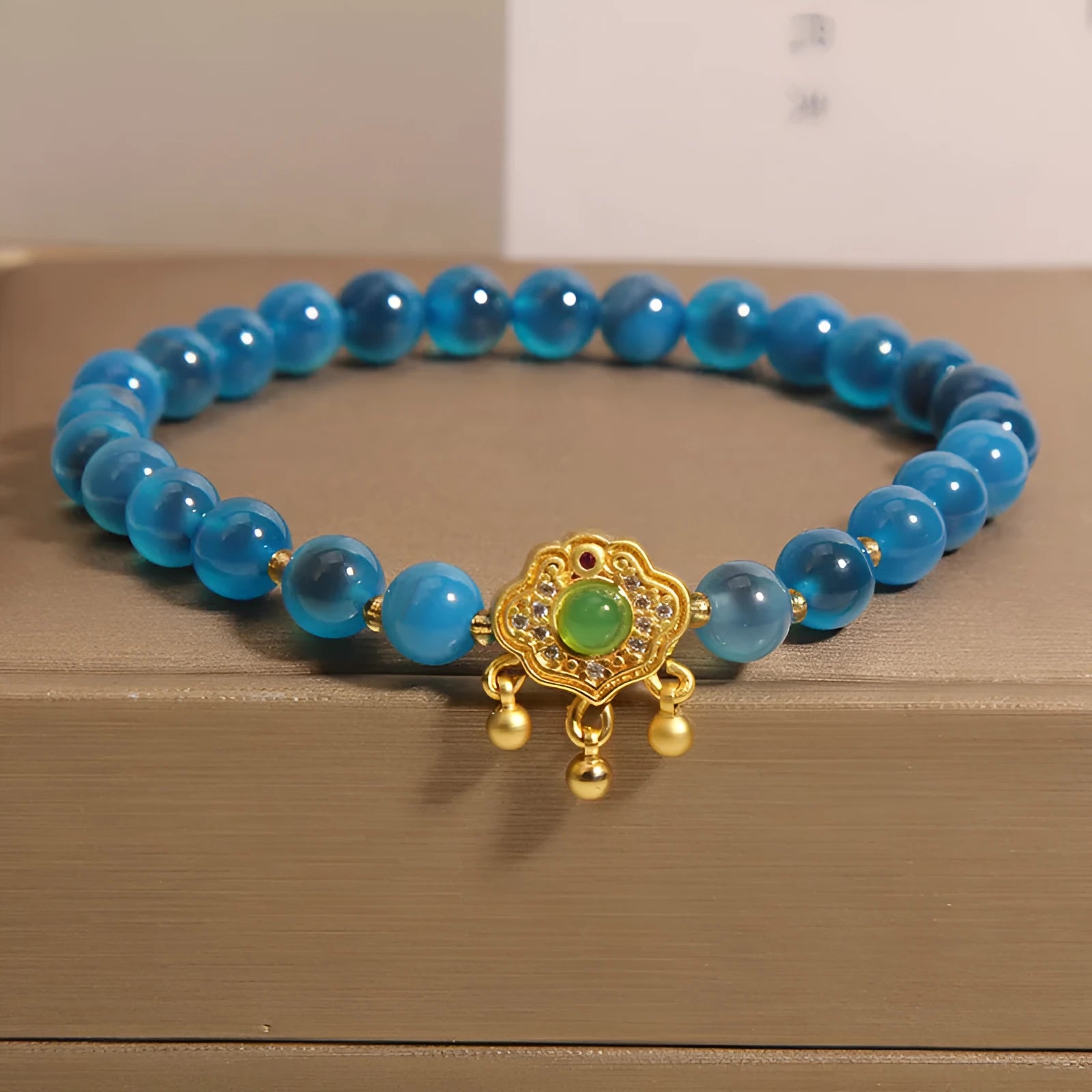 Blue sugar heart agate safety lock pendant on a women's crystal bracelet with alloy inlay and rhinestones.