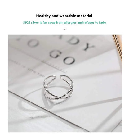 Silver plated geometric cross ring for women with adjustable opening on a white background