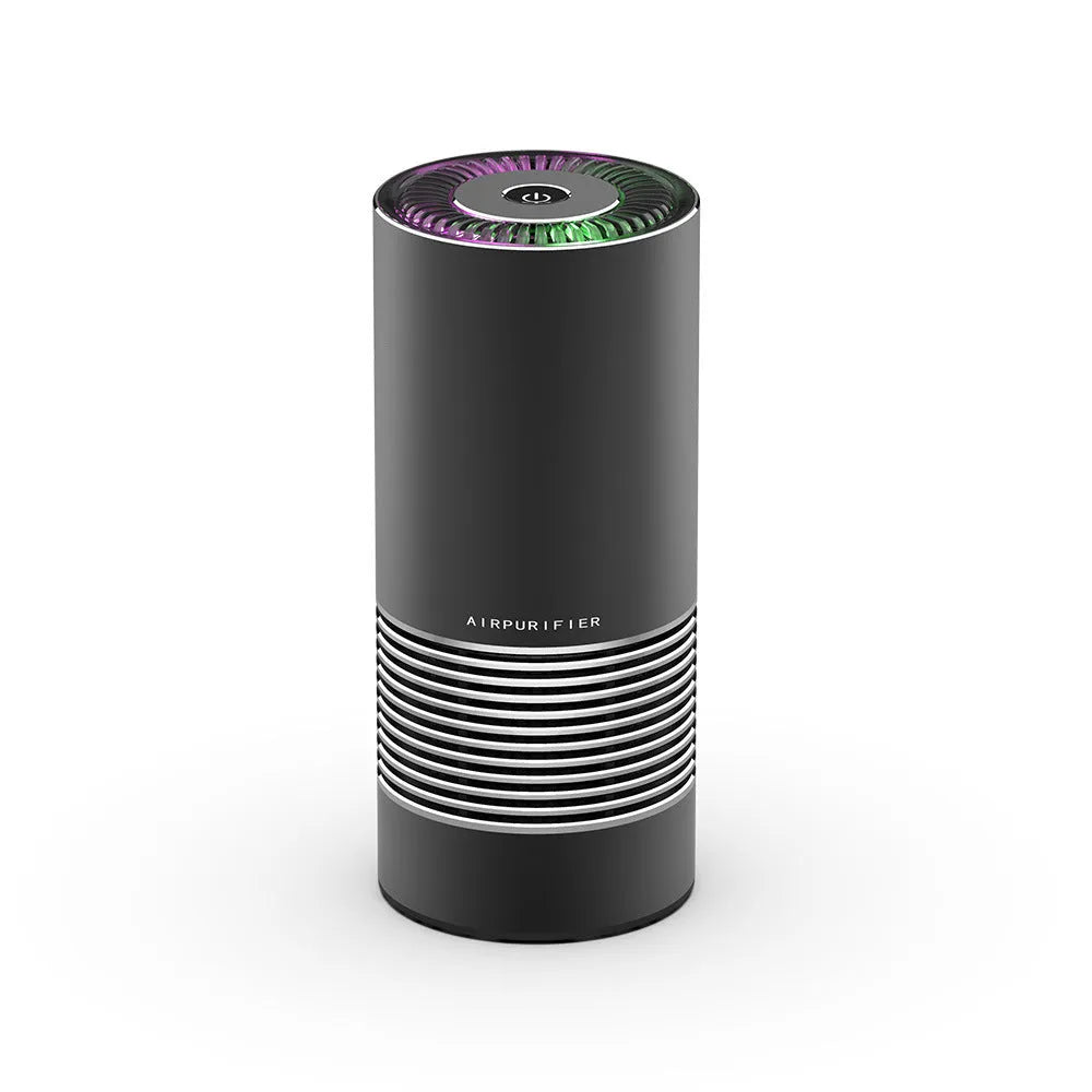 Compact black car air purifier with aluminium alloy and ABS construction, shown next to a car USB port.