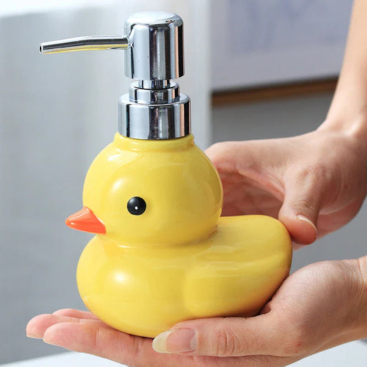 Adorable yellow ceramic soap dispenser with duck design and matching soap dish