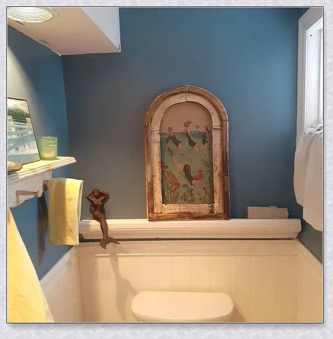 Decorative wall art featuring multiple swimmers and mermaids in a serene, aquatic-themed design