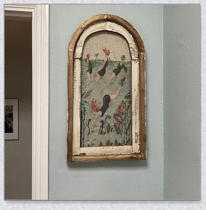 Decorative wall art featuring multiple swimmers and mermaids in a serene, aquatic-themed design