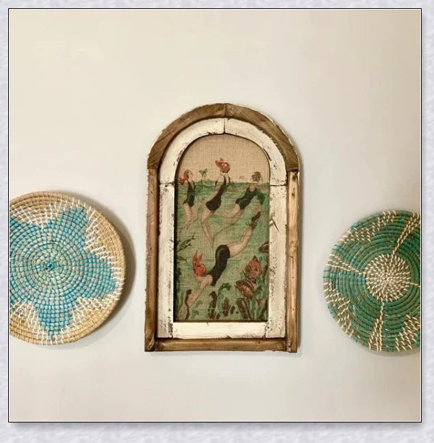 Decorative wall art featuring multiple swimmers and mermaids in a serene, aquatic-themed design